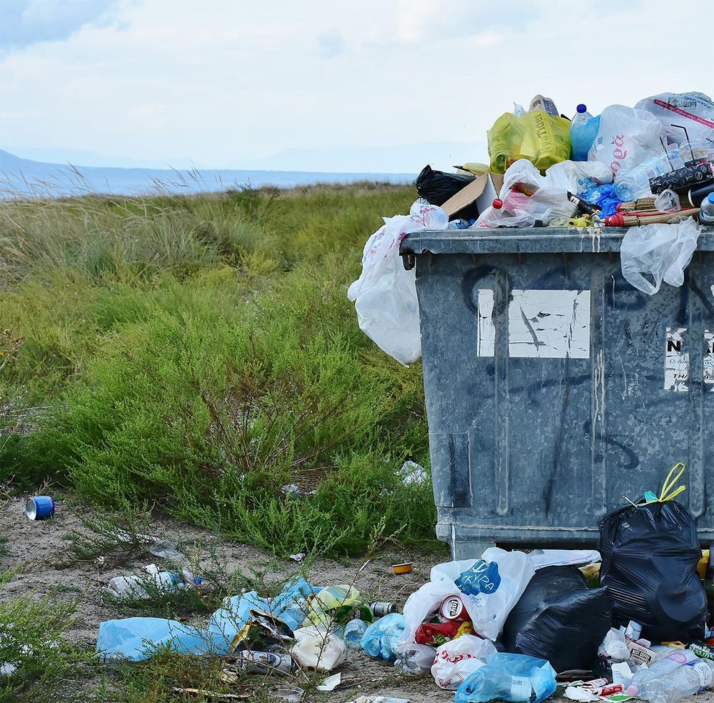 Photo of an overflowing trash container in the prairies.